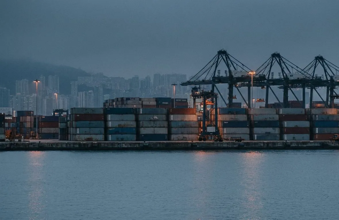 Container terminal at dusk with gantry cranes and stacked containers